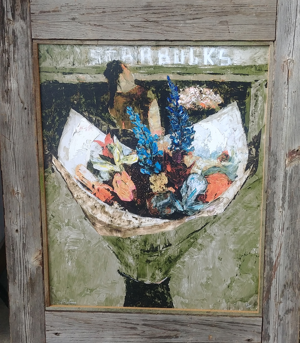 A painting of flowers below a Starbucks sign